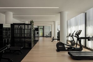 A modern gym with exercise equipment, a wooden floor, and large windows. - Little National Hotel Adelaide (Adelaide)