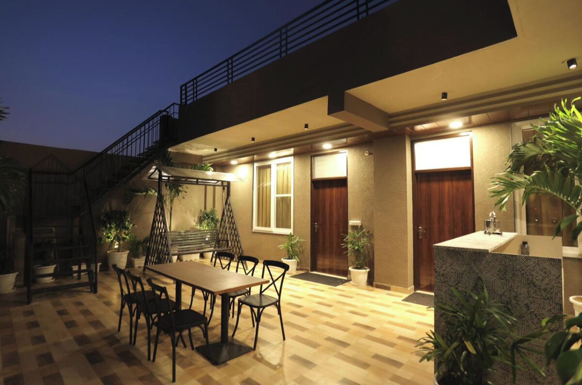 A modern hotel with a dining area, a staircase, and a reception desk.