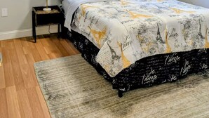 A bedroom with a bed, a window, a nightstand, and a lamp. - Entire home in Folsom, California (Folsom)