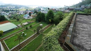 A residential area with houses, a church, and a well-maintained garden. - Ashley Resorts Nuwaraeliya (Nuwara Eliya)