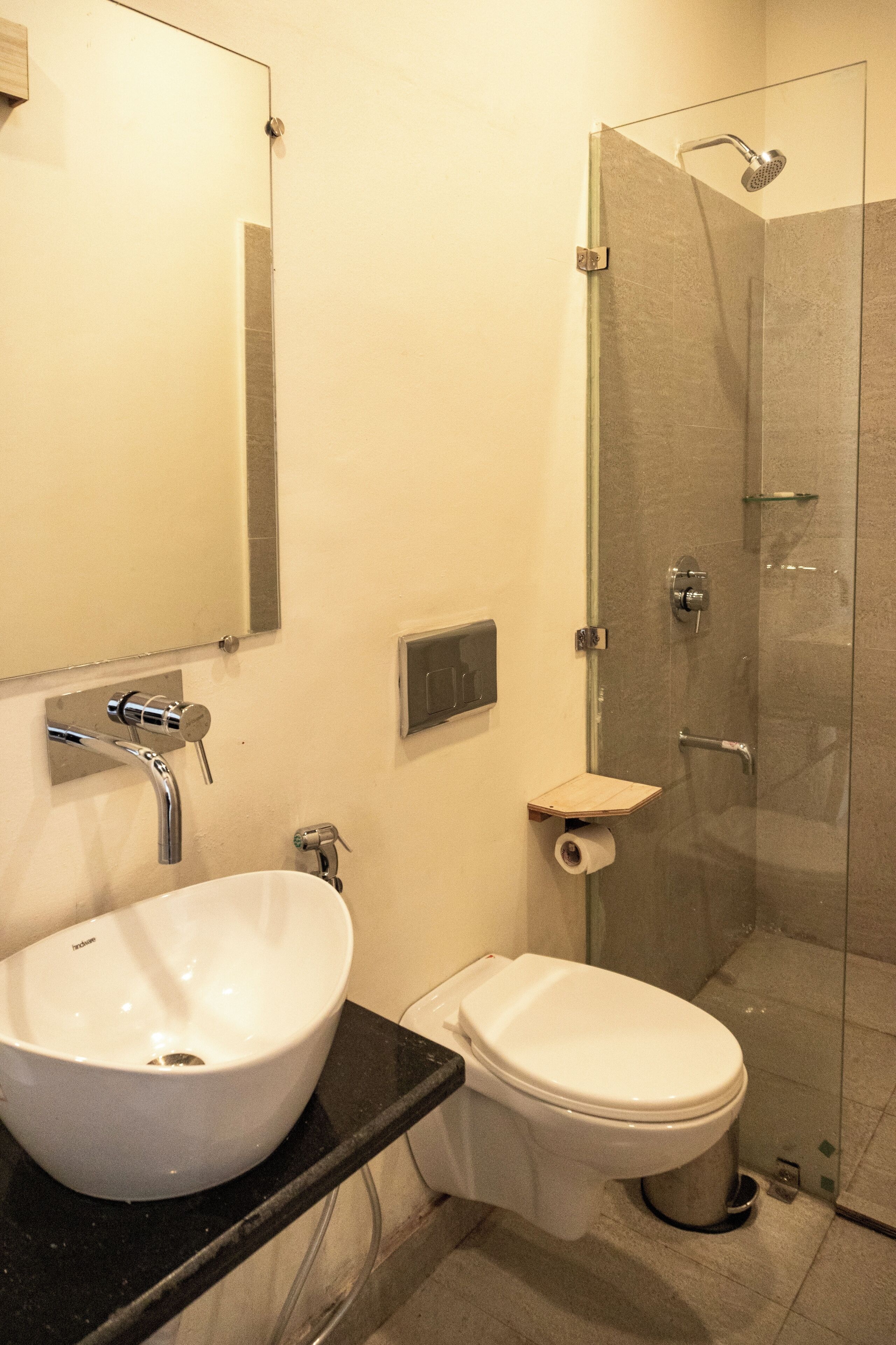 A bathroom with a white sink, toilet, and a glass-enclosed shower.
