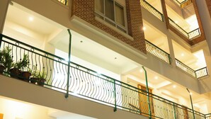 A multi-story hotel with balconies, a staircase, and a sign for Batuan Homes Hotel & Restaurant. - Batuwa Homes (Kathmandu)