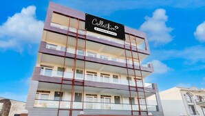 A multi-story building with a sign reading "Collection Company-Serviced". - Collection O Sector 1 Manesar (Gurugram)