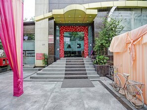 A hotel entrance with a staircase leading up to a glass door, a 'No Smoking' sign, and a 'Booking Office' sign. - Townhouse Prakash Continental (New Delhi)