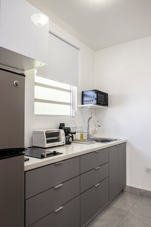 A modern kitchen with a built-in oven, a coffee maker, and a microwave. - Getaway awaits in San Juan (San Juan)
