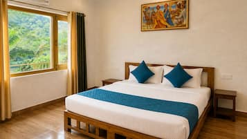 A hotel room with a large bed, a painting on the wall, and a window with curtains.