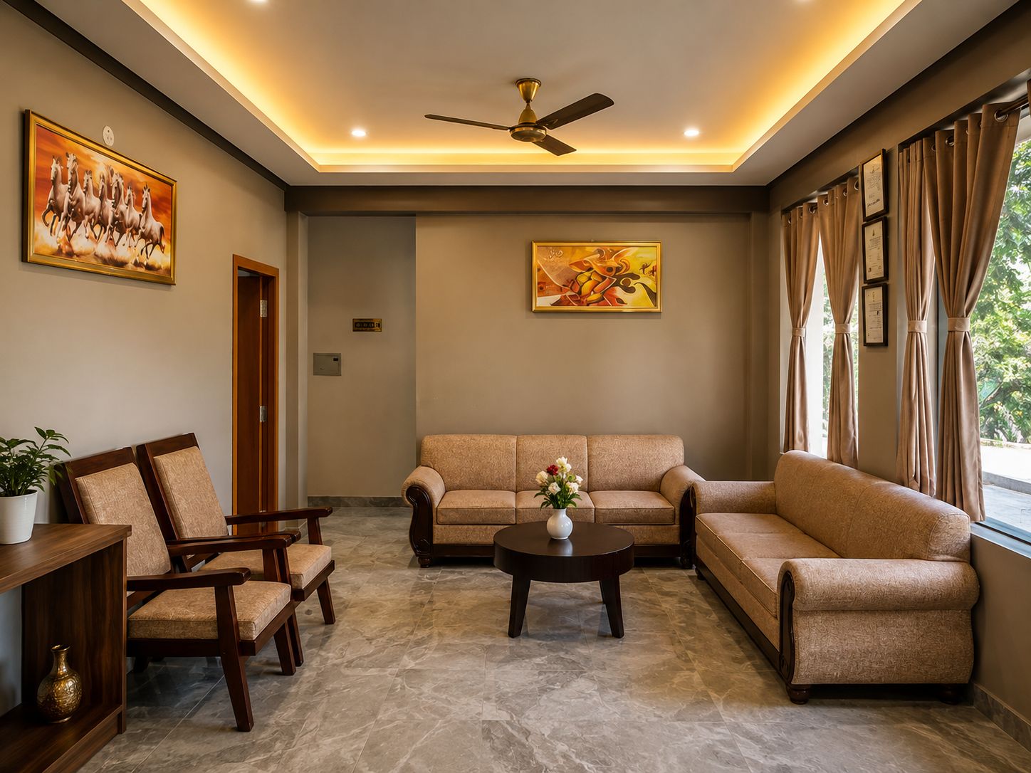 A well-lit living room with a sofa set, chairs, a coffee table, and artwork on the walls.