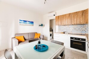A modern kitchen with wooden cabinets, a built-in oven, and a tiled backsplash. - Patio, air conditioning and communal pool (Castelsardo)
