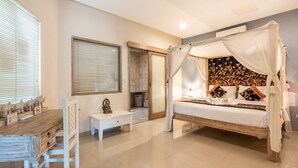 A bedroom with a wooden bed, white bedside tables, a nightstand, a window with blinds, and a decorative wall panel. - Private Pool | Daily Housekeeping | Central Seminyak (Seminyak)