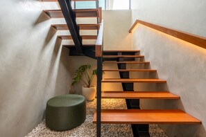 A modern staircase with wooden steps and metal railings, leading to an upper floor. - Luxury Ricefield Villa | Pool | Near Berawa (Kerobokan)