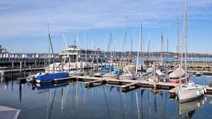 A marina with multiple boats docked at piers. - Small house | city location | seeglueck (Konstanz)