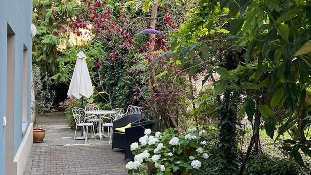 A patio area with outdoor furniture, a table, and a chair. - Small house | city location | seeglueck (Konstanz)