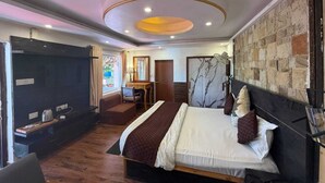 Un dormitorio moderno con una cama, un escritorio y un televisor.
