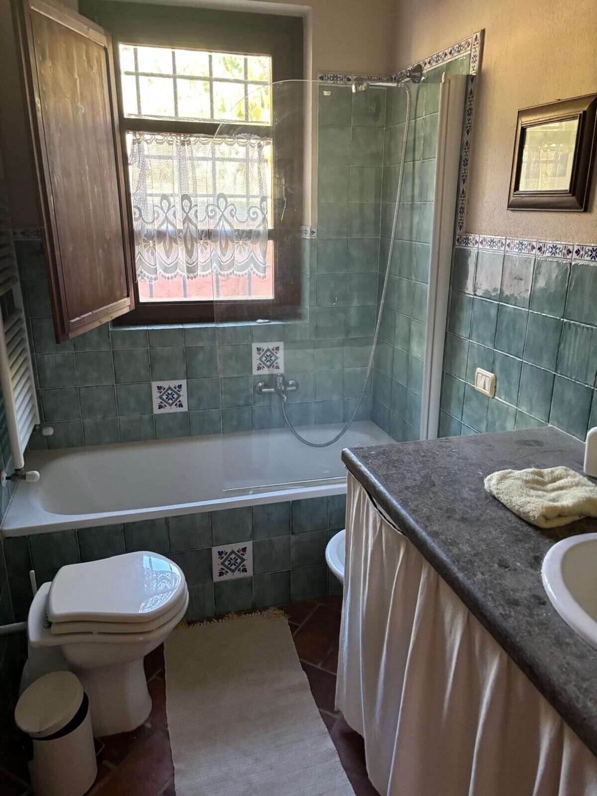 A bathroom with a bathtub, toilet, and sink.