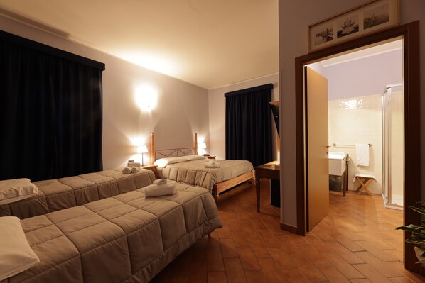 A hotel room with two beds, a bathroom, and a wooden floor. - HOTEL LOCANDA DELL'OCA BIANCA (Como)