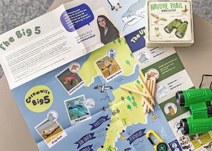 A nature trail game board with wildlife illustrations, a binoculars box, and a map of Cornwall's Big 5. - Premium 4-bedroom Holiday Home sleeps 8 Pet Friend (Hayle)