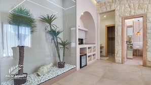 A modern interior with a stone wall, a white shelving unit, and a doorway leading to another room. - Bungalow Targa - Heated swimming pool not overlooked (Marrakech)