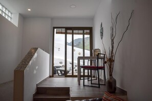 A staircase leading to a dining area with a view of a snowy landscape.