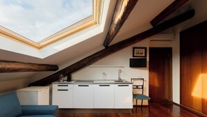 A modern kitchen with a skylight, wooden beams, and a built-in sink. - Castello Sforzesco, Lieux Caches Undermyname (Milano)
