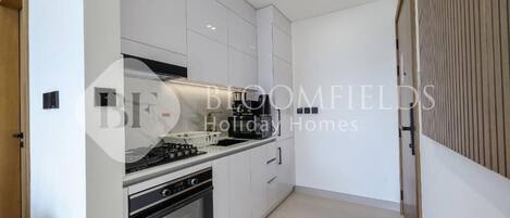 Departamento, balcón, vista a la ciudad | Cocina privada