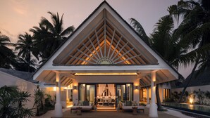 A resort with a covered outdoor seating area, a pool, and palm trees. - RAH GILI MALDIVES (Mahaanaelhihuraa)