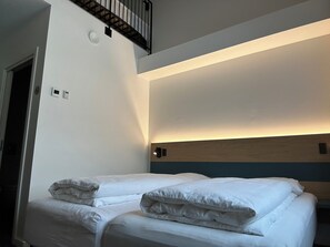 Deluxe Quadruple Room, Partial Sea View | Desk, laptop workspace, blackout curtains, soundproofing - Hotel Aurora (Nuuk)