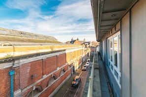A long corridor with a brick building on one side and a modern structure on the other. - Dean Swift Square by Dublin At Home (Dublin)