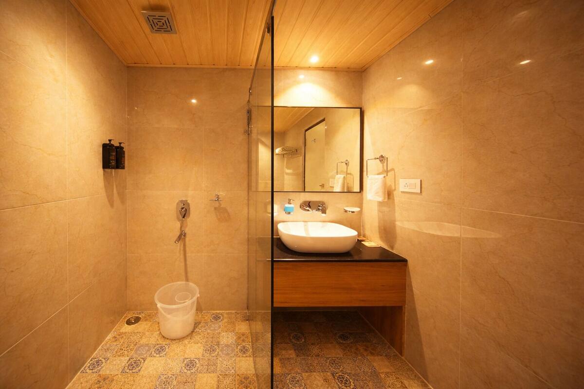 A bathroom with a shower, a sink, and a mirror.