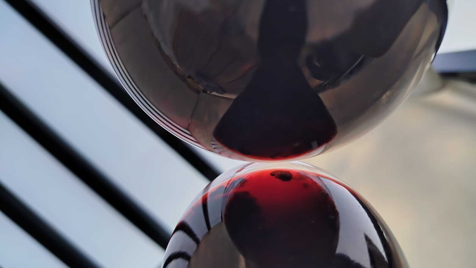 A close-up of a reflective object with a dark center and lighter edges, possibly a glass or metal item.