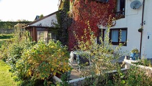 A house with a garden, a wooden deck, and a satellite dish. - Achnabobane Farmhouse (Spean Bridge)