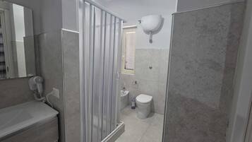 Deluxe Condo | Bathroom | Shower, free toiletries, hair dryer, slippers
