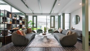 A modern living room with two grey sofas, a coffee table, and a bookshelf. - The Lookout by Dublin At Home (Dublin)