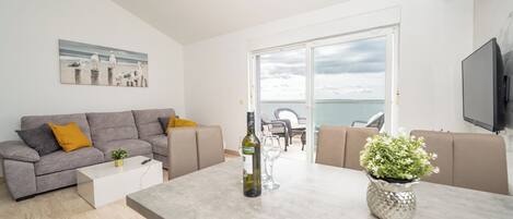 Standard Apartment, Patio, Sea View | Living area | 45-inch flat-screen TV with cable channels