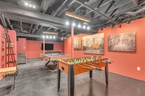 An indoor space with a foosball table, a pool table, and artwork on the walls. - Hot Tub Fire Pit Huge Yard Dual Homes Sleeps 18 (Suffern)