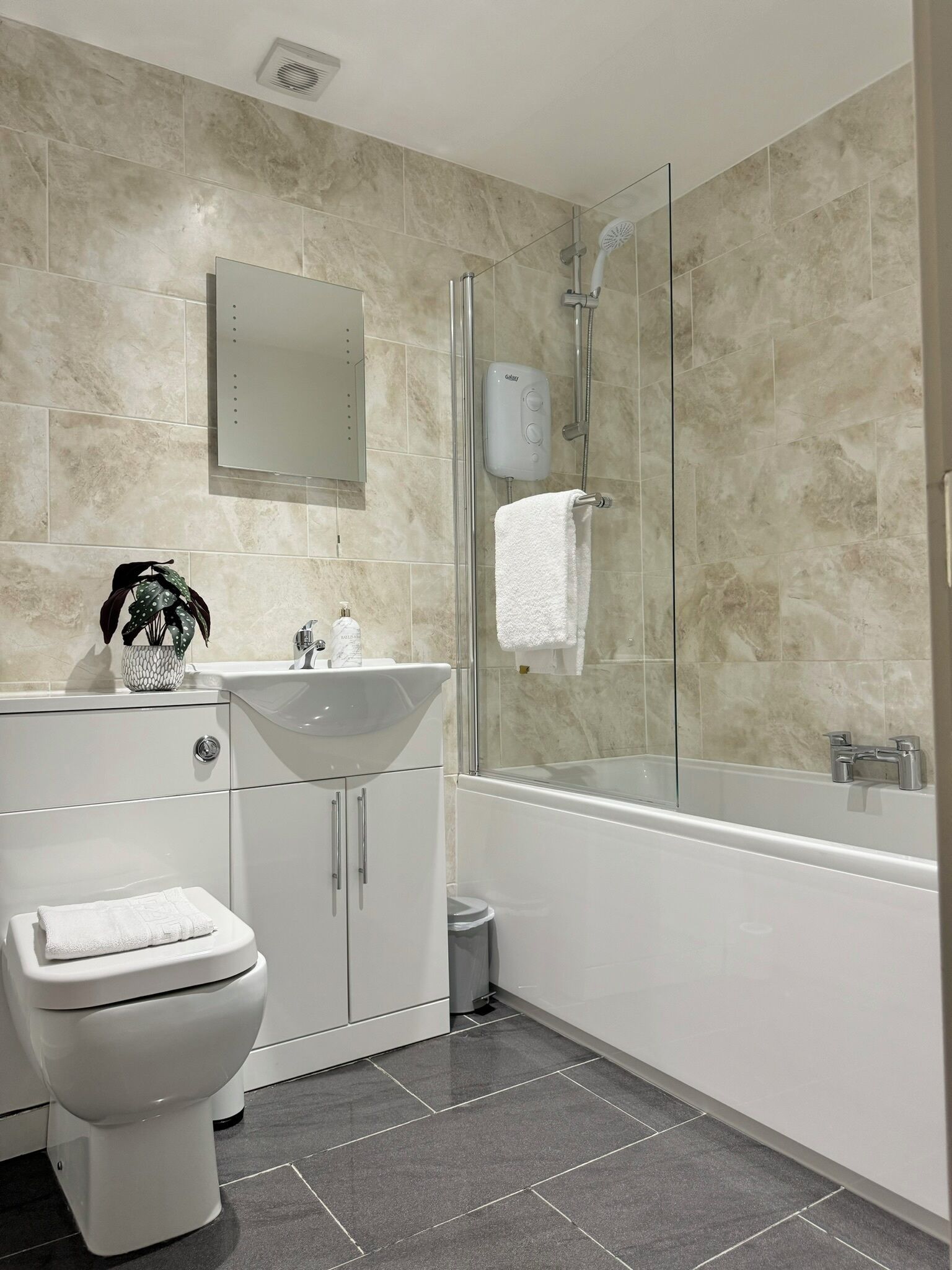 Shower, hair dryer, towels, toilet paper