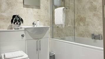 Shower, hair dryer, towels, toilet paper
