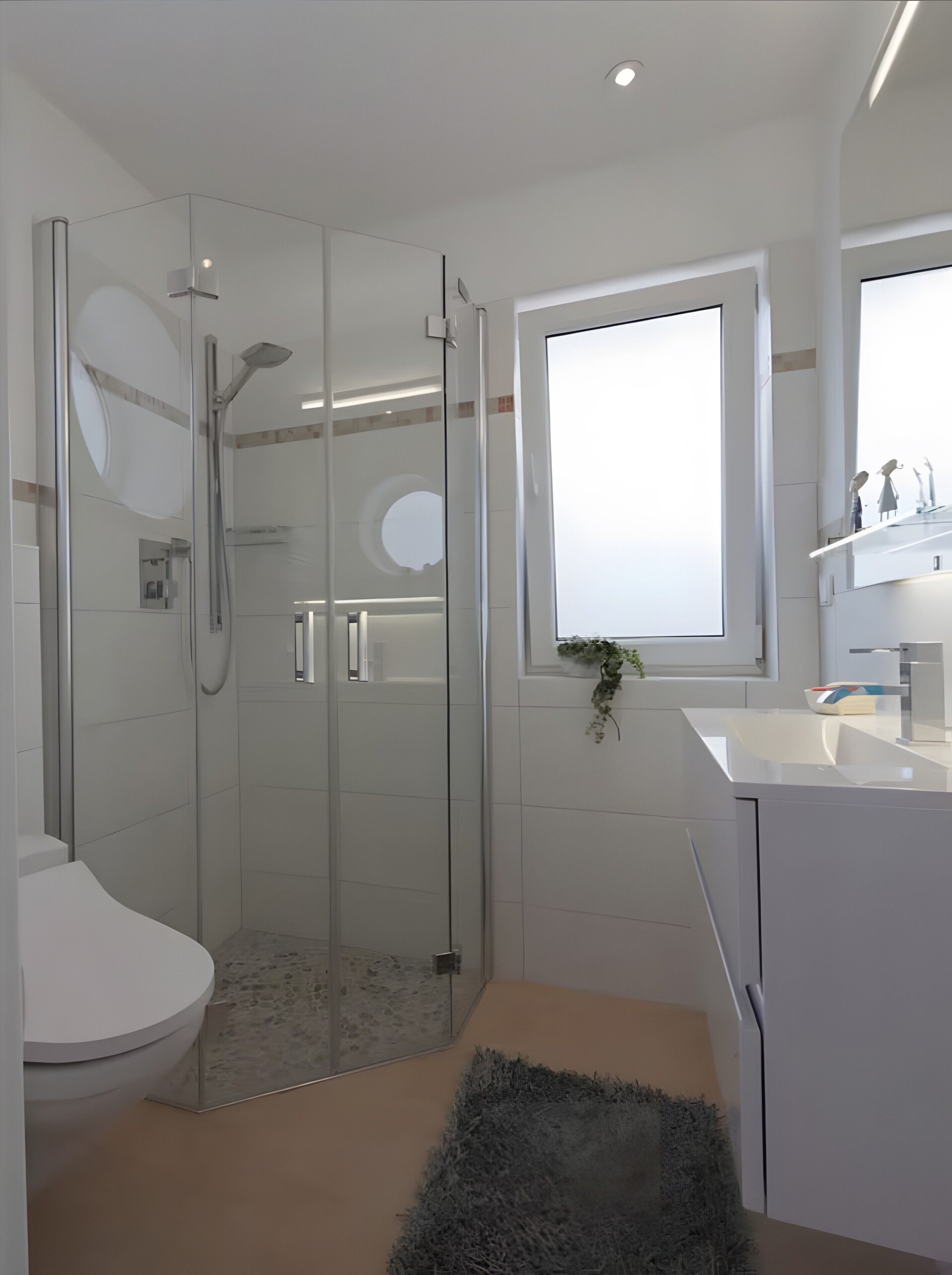 Un baño moderno con cabina de ducha de vidrio, un lavabo blanco y un espejo sobre el lavabo.
