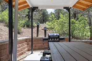 A covered outdoor patio with a grill, benches, and birdhouses. - Zion's Emerald| Walk into East Zion| Amazing Stars (Orderville)