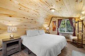 A cozy bedroom with a wooden ceiling, a bed with white bedding, a nightstand with a lamp, and a window with curtains. - Zion's Emerald| Walk into East Zion| Amazing Stars (Orderville)