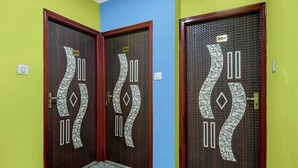 A hallway with two doors, each marked with a number and a unique pattern. - Hotel O Metropolis Mall Kolkata (Barasat)
