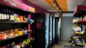 A store interior with shelves of various products, a Nestle freezer, and a 'fast 4 you' sign. - 1505 Lazer conforto e tranquilidade (Cabedelo)