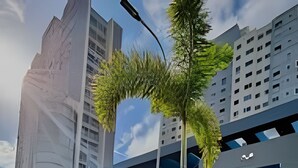 Un edificio moderno con un design architettonico unico, caratterizzato da un mix di elementi in vetro e cemento, immerso nel verde.