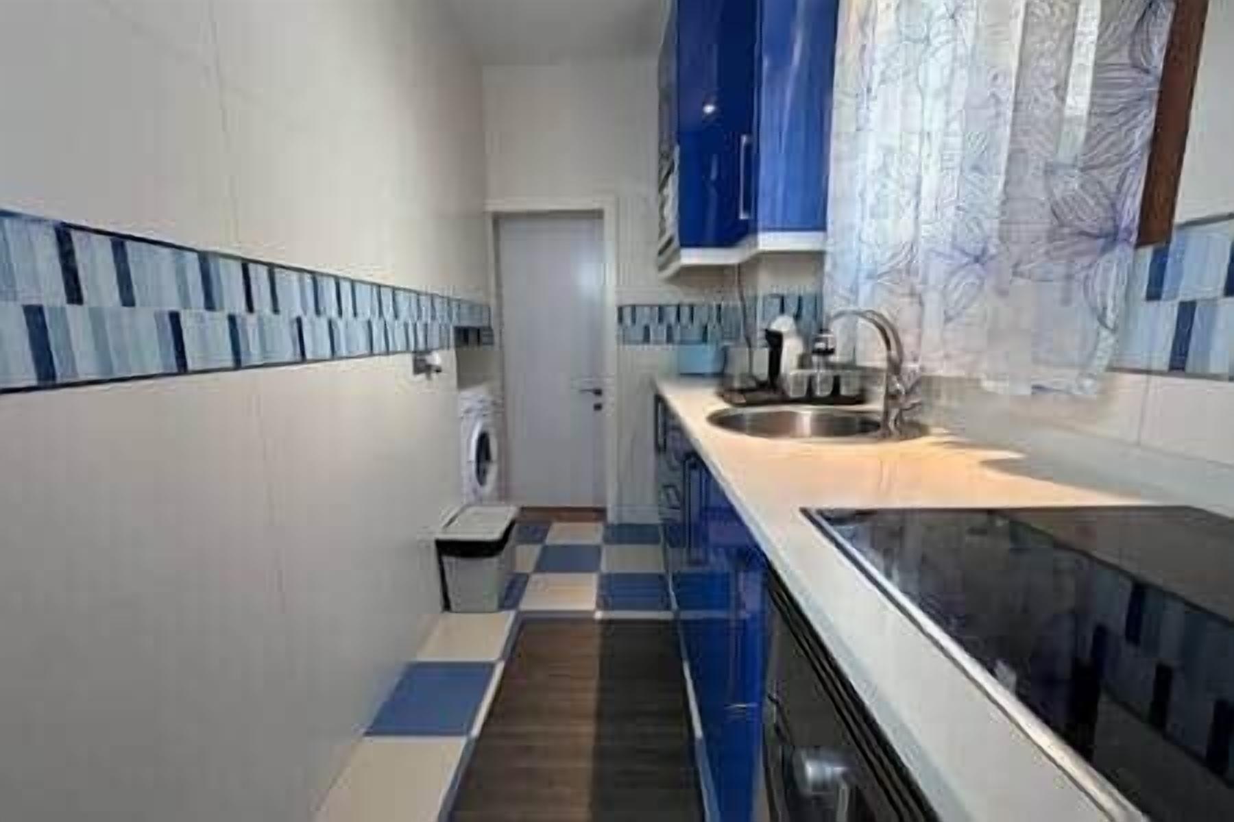 A compact kitchen with a dishwasher, a sink, and a stove.