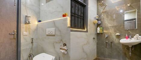 A modern bathroom with a toilet, bidet, and shower.