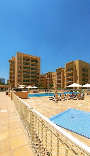 Outdoor pool, a heated pool - SettlerHomes - Fresh Studio - Balcony - The Greens (Dubai)