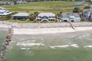 A coastal property with a beach, a large house with multiple levels, and a rocky shoreline. - Oceanfront, Direct Beach Access, Panoramic Views - 510 Tarpon Blvd (Fripp Island)