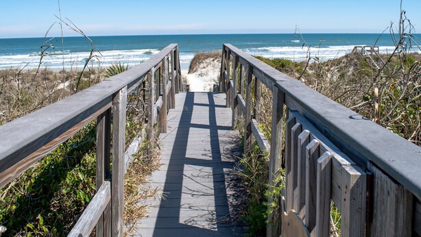 A wooden boardwalk leading to the beach with a clear view of the ocean. - Private Beach Front: Rustic Dune Retreat (St. Augustine)