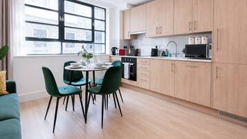 Fridge, stovetop, dishwasher, coffee/tea maker