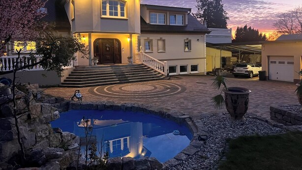 A large house with a swimming pool, a garage, and a driveway. - Merzhausen Castle in the Taunus region near Frankfurt am Main - west wing (Usingen)