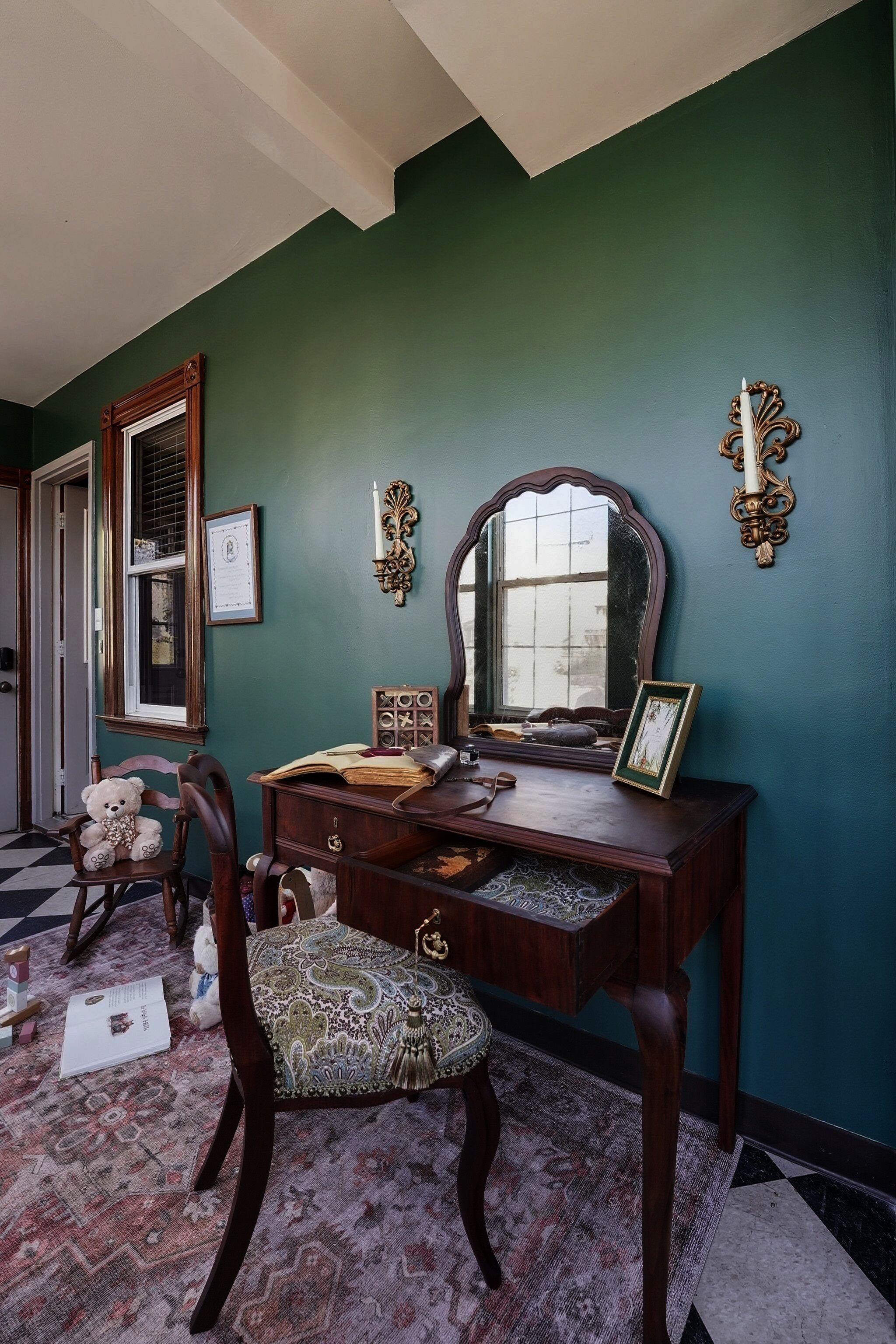 A dining area with a wooden table, chairs, and a large mirror.